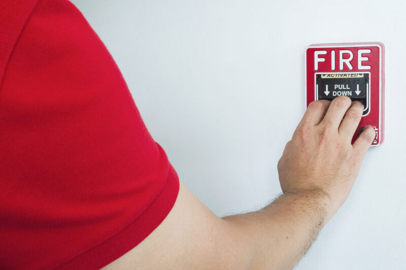 Licensed technician testing fire alarms for inspection
