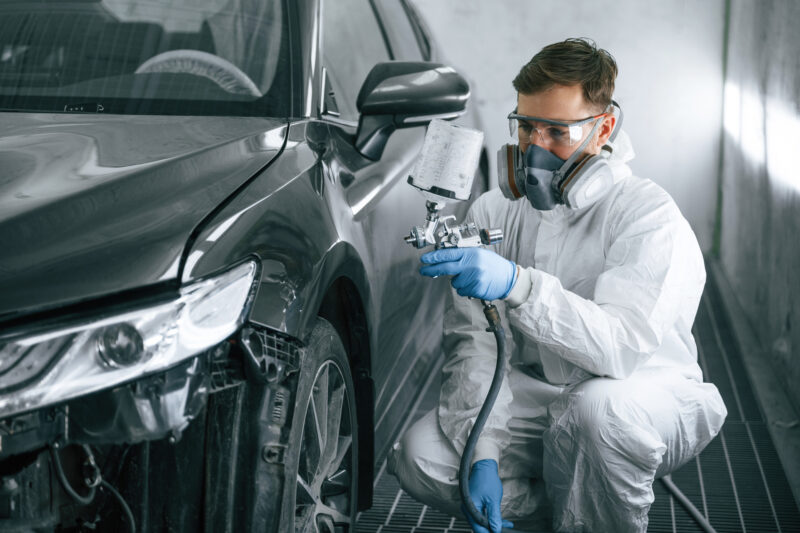 paint spray booth man spraying car